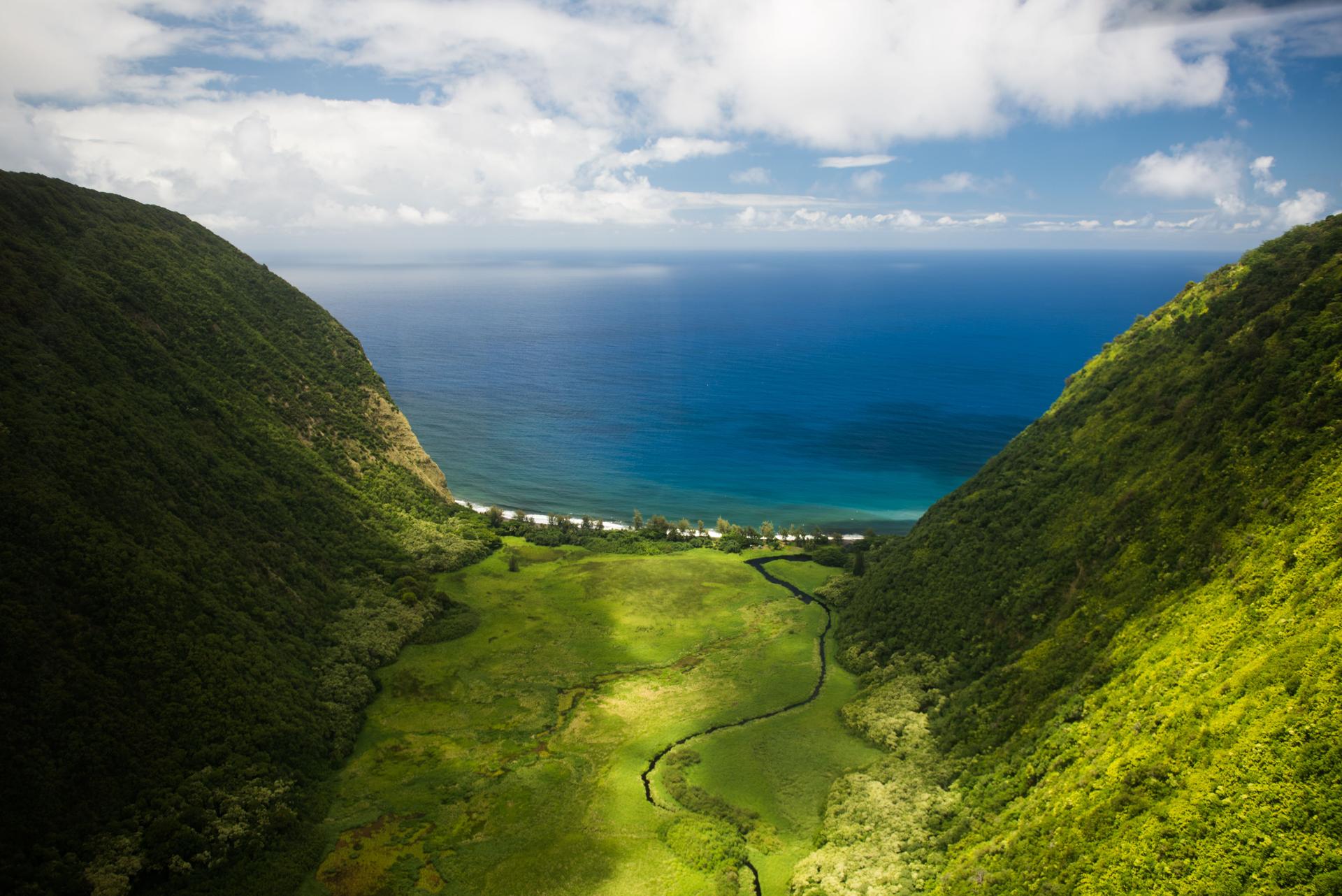 Aerial Shot Of Waipi'o Valley On Big Island, Hawai'i, With The Pacific Ocean In The Background.